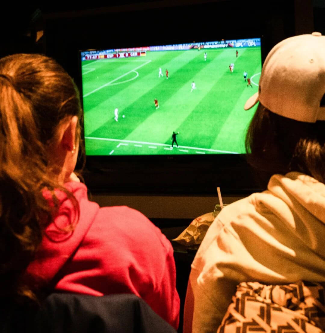 two people watching a soccer game