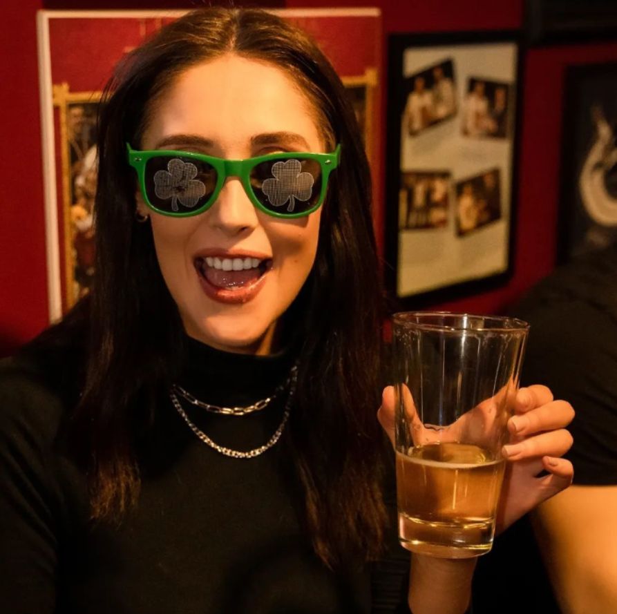 Shamrock sunglasses and a beer being enjoyed by St. Patrick's Day celebrator! | The Pint Vancouver